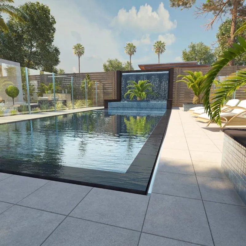 A water feature spilling into a pool beside a tiled jacuzzi