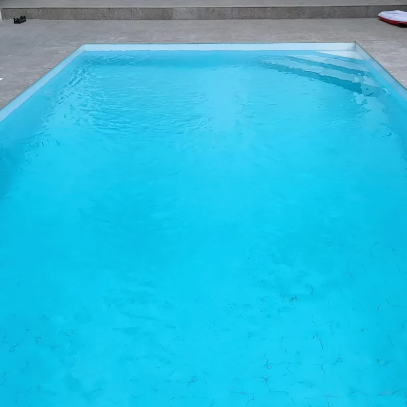 A clean, well-kept pool with clear water and a swept floor