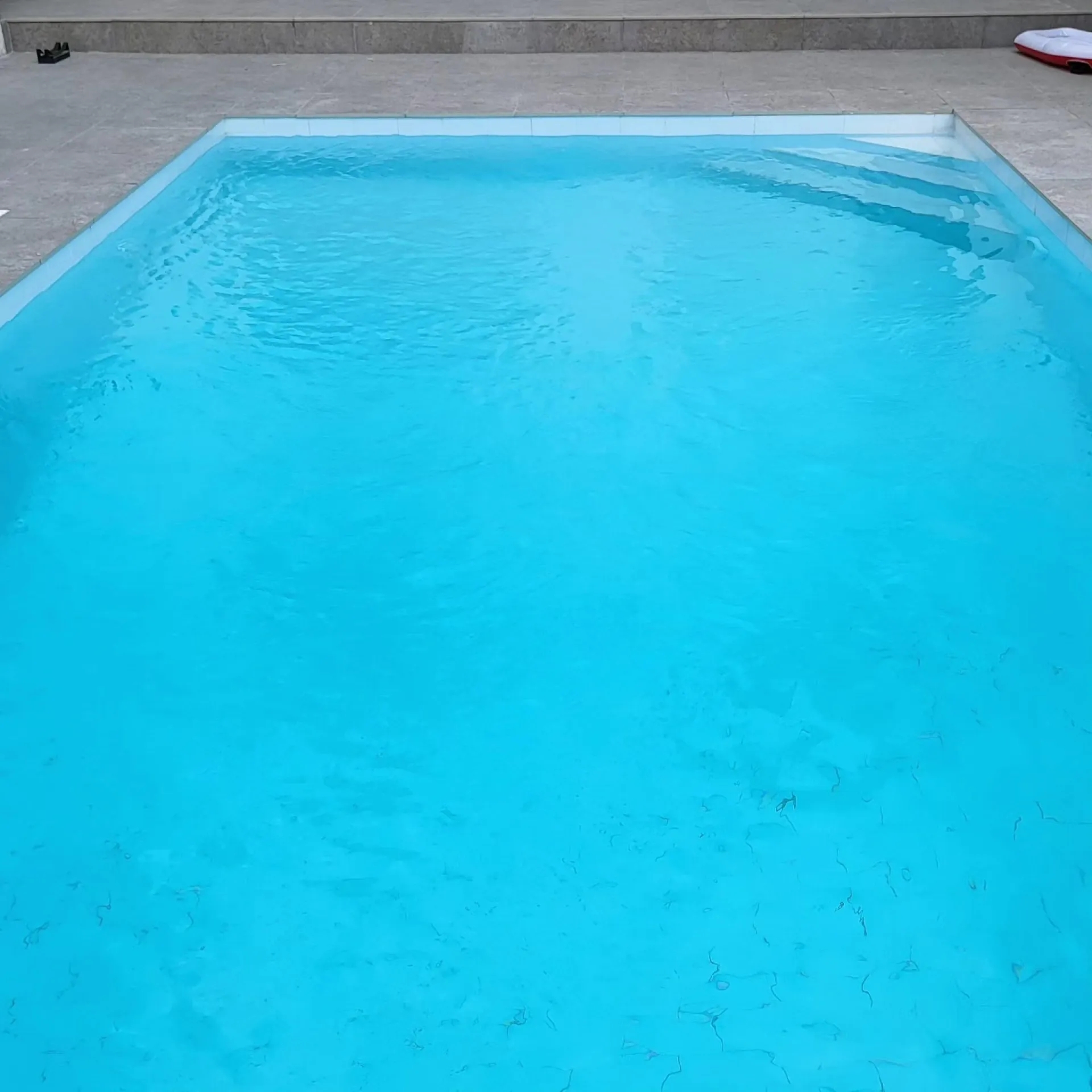 A clean, well-kept pool with clear water and a swept floor