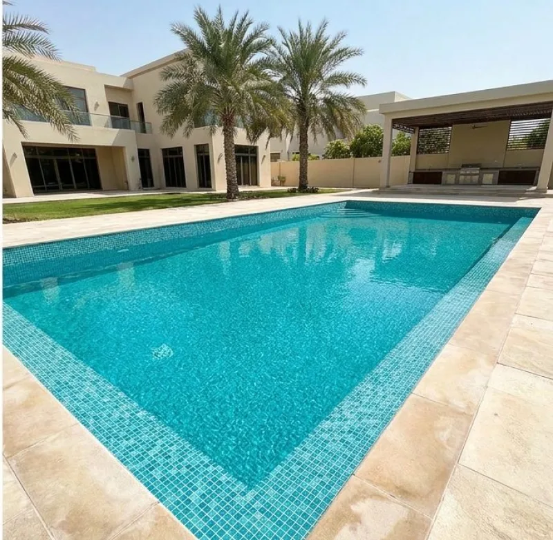 The same pool with clear turquoise water and a clean waterline, in front of a Dubai villa and palms